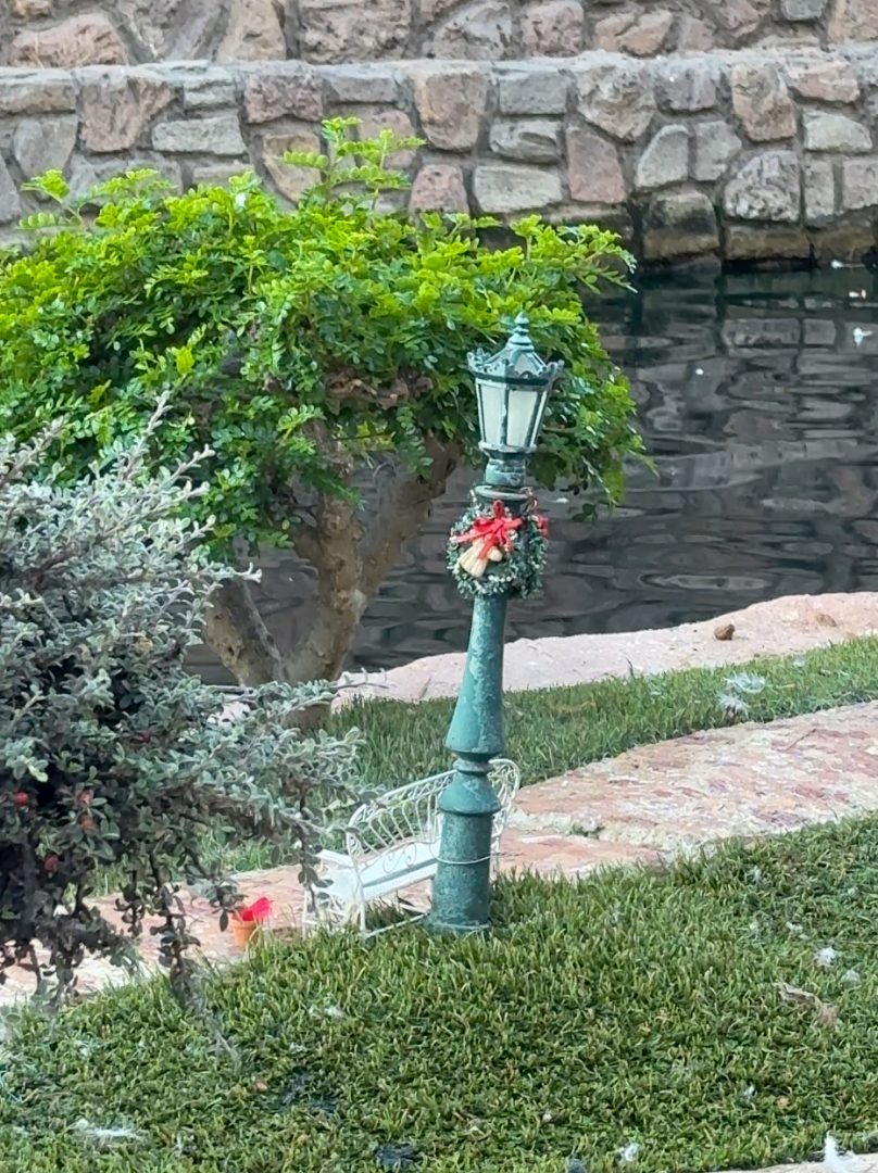 A lamppost on Peter Pan island adorned with a festive wreath.