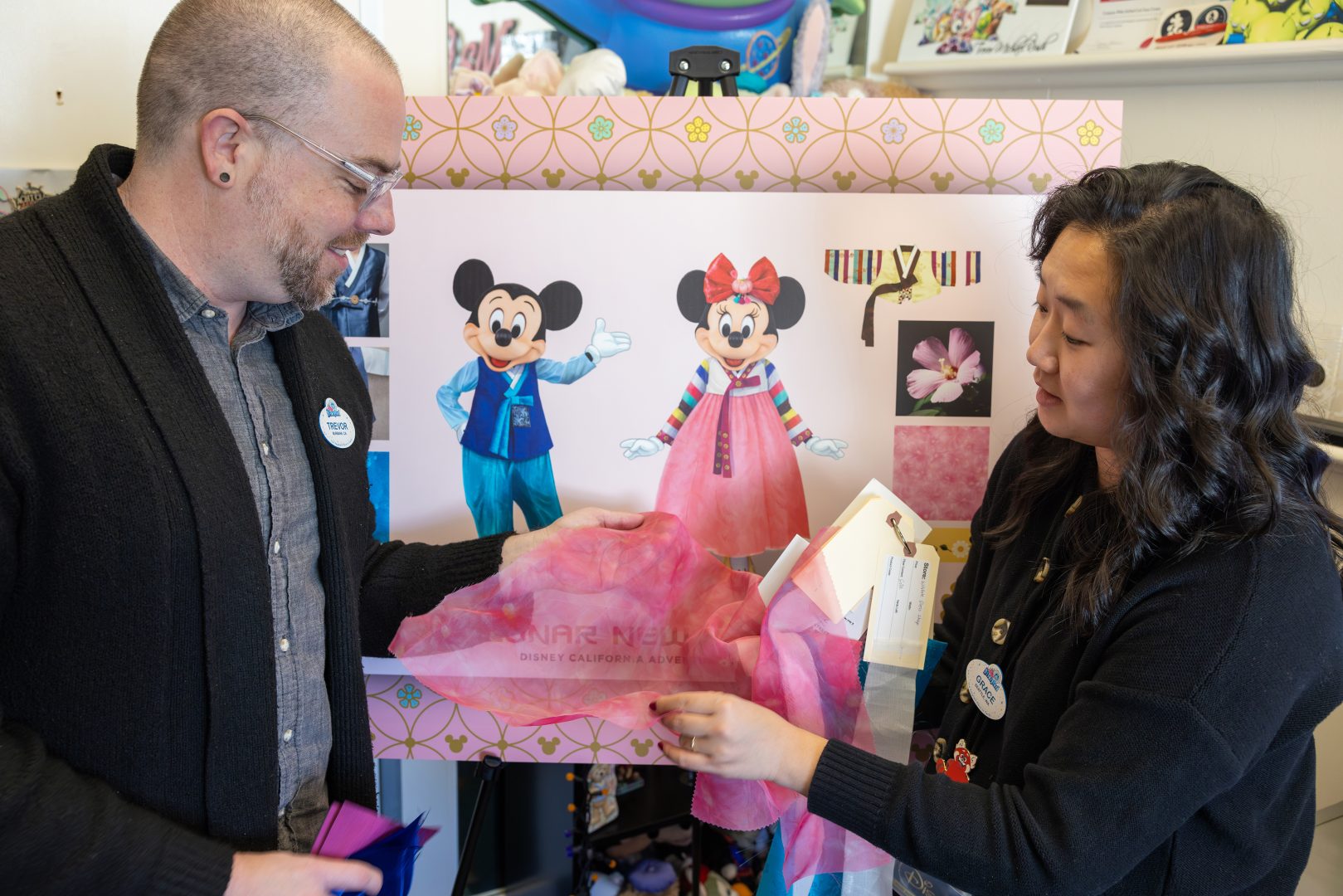 Grace with teammate Trevor Rush, costume producer, looking over fabric swatches.