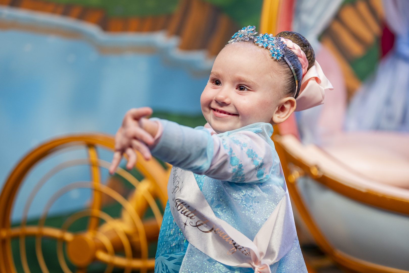 A Make-A-Wish child poses for a royal photoshoot in Disneyland park following her princess transformation at Bibbidi Bobbidi Boutique on World Wish Day.