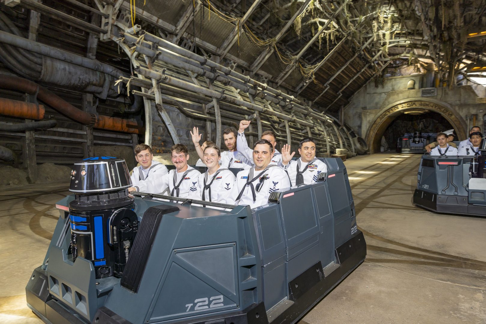 Service members wave after experiencing Star Wars: Rise of the Resistance.